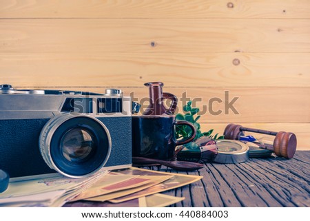 image of Retro camera and vary of decoration on wood table background(vintage color tone)