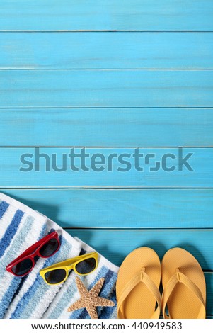 Summer beach background border, sunglasses, flip flops, starfish, copy space, vertical