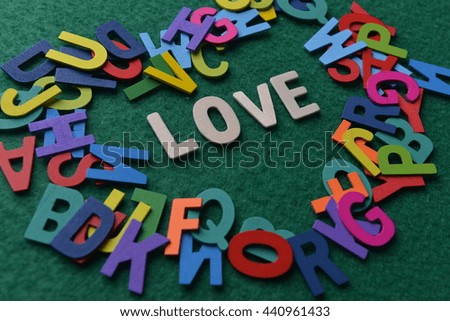 LOVE word on green background with of the alphabets.