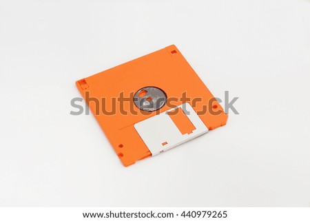 Back side of floppy disk (orange color) isolated on white background.