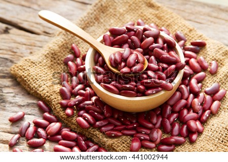 Grains Red bean in wooden bowl and spoon putting on linen and wood background Royalty-Free Stock Photo #441002944