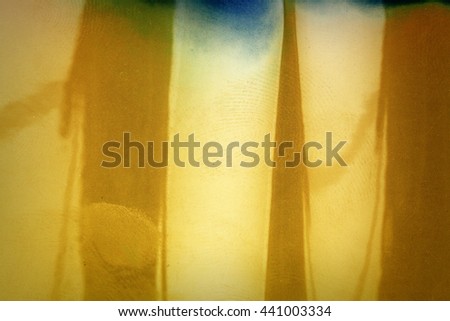 Blank yellow vibrant noisy film strip texture background with fingerprints