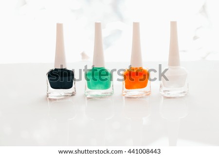 colored nail polish on a white background.