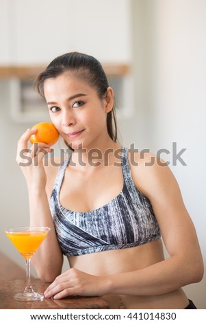 woman carry orange with a glass of juice