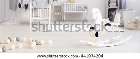 Panoramic picture of a rocking horse in a beautiful children's room
