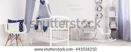 Panoramic picture of a crib in a cozy baby room