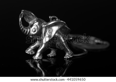 Elephant pendant of silver on a black background.