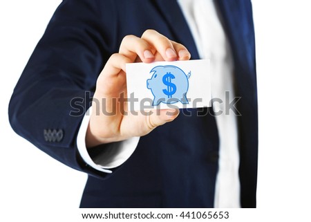 Elegant man in suit holding business card with picture of piggy bank , isolated on white