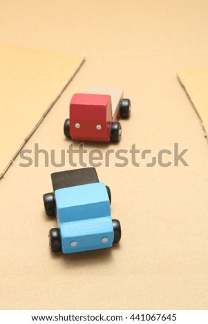 Toy car trucks on cardboard. 