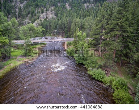 Cache la Poudre River and Pingree Park Road bridge - aerial view in early summer
