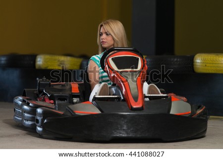 Young Woman Is Driving Go-Kart Car With Speed In A Playground Racing Track - Go Kart Is A Popular Leisure Motor Sports