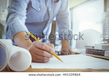 Architect or engineer working in office, Construction concept. Engineering tools.Vintage tone retro filter effect,soft focus(selective focus). Royalty-Free Stock Photo #441109864
