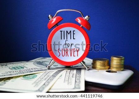 Time for survey. Sign on red clocks with cash and coins on background