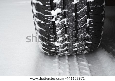Closeup of winter tire on a road covered with snow