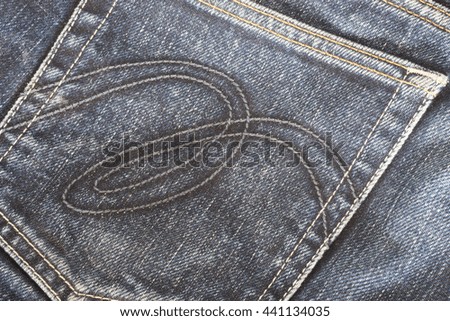 Back pocket of black denim jeans background texture.
