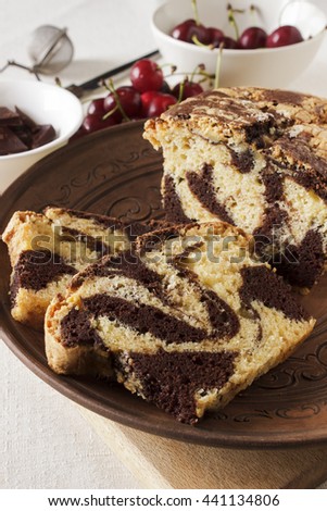 Marble Pound Cake, Cherries and Chocolate, cutting board on a white linen tablecloth
