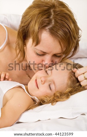 Waking up to a happy day - woman and little girl in the morning