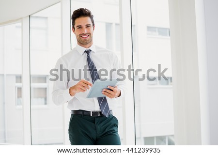 A man is holding a notebook and smiling at office Royalty-Free Stock Photo #441239935