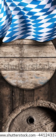Blue and white Bavarian national flag with old vintage oak beer barrels in a brewery, cellar or tavern conceptual of the annual Munich Oktoberfest, vertical banner