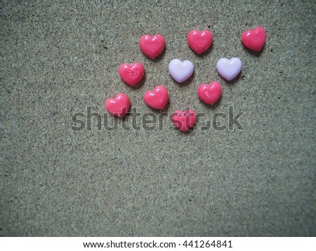 Cork board with heart shape pins for background