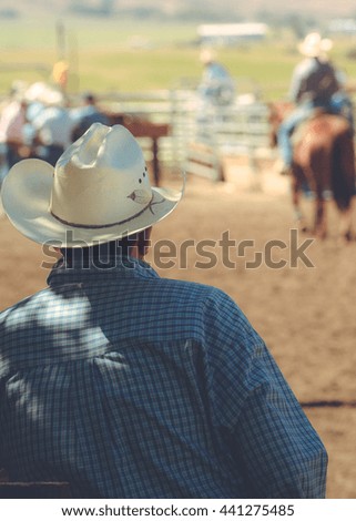 Rear view of man wearing cowboy hat.