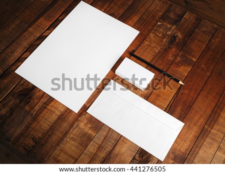 Photo of blank stationery set. Blank corporate identity template on wooden table background. Mock-up for design presentations and portfolios.