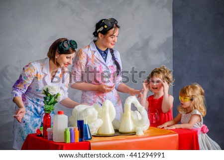 Crazy professor conducting chemical experiments in the company of a little girls.
