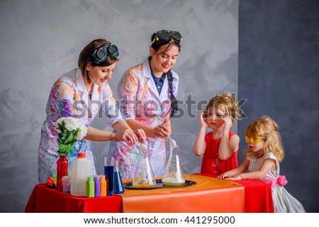 Crazy professor conducting chemical experiments in the company of a little girls.