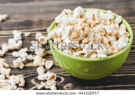 Sweet Caramel Popcorn in Green Bowl on Wooden Background