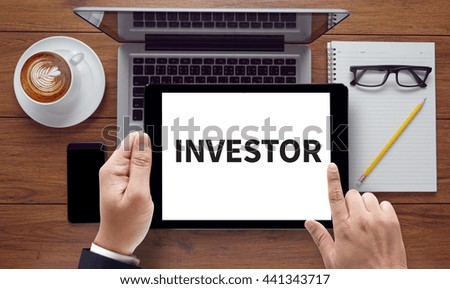 INVESTOR, on the tablet pc screen held by businessman hands - online, top view