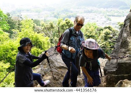 asian family enjoying the view from mountain. Royalty-Free Stock Photo #441356176