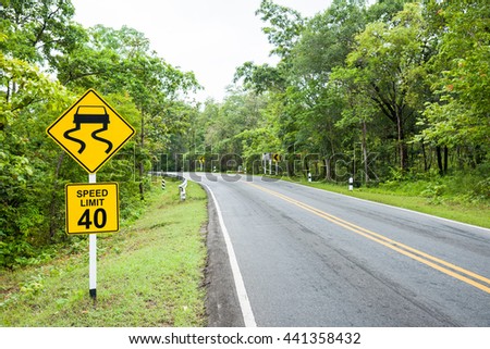 Yellow slippery road with speed limit sign on high way.