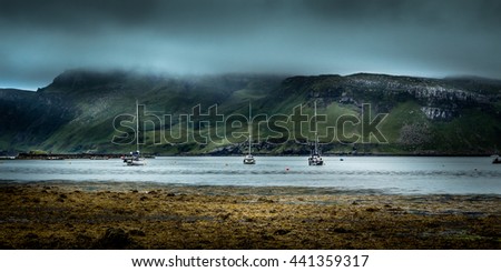 Sailboats With Stone Beach And Misty Hills With Silky Long Exposure Clouds In Background
