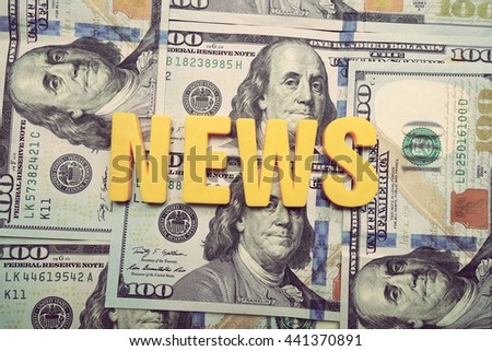 News concept. Yellow letters on a background of US dollars