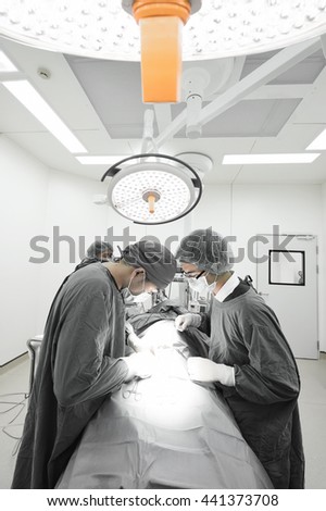 group of veterinarian surgery in operation room take with selective color technique and art lighting