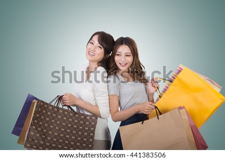 Asian shopping woman with her friends holding bags.