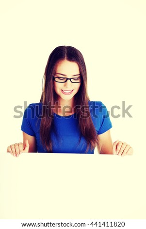 Young beautiful casual woman holding copy space.