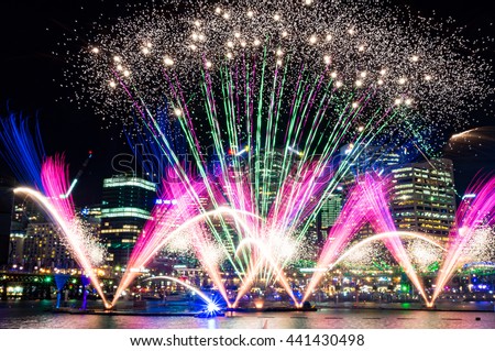 Colorful fireworks on the water at Darling Harbour as part of annual lighting festival Vivid Sydney: Festival of Light, Music and Ideas Royalty-Free Stock Photo #441430498