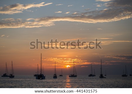 Many yachts and boats in Naiharn bay among sun set atmosphere in Phuket, Thailand.