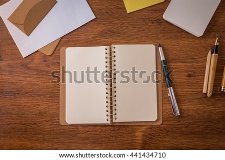 Background wood table with notebook
