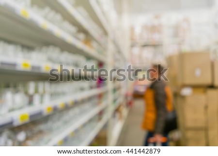 People are shopping in a supermarket. Blur and defocus image as a background and postcard designs.