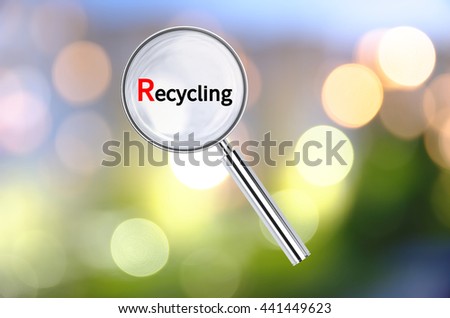 Magnifying lens over background with text Recycling, with the blurred lights visible in the background. 3D rendering.
