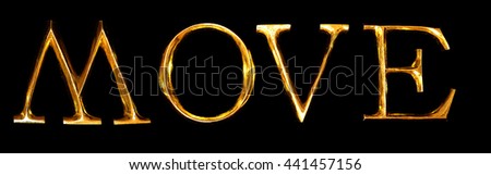 Wooden letters in gold on black background spelling MOVE
