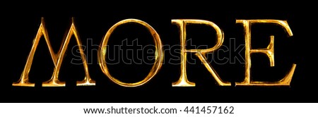 Wooden letters in gold on black background spelling MORE