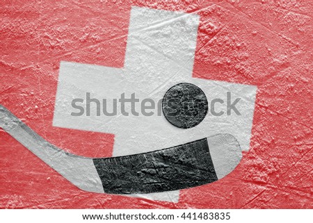 The image of the Swiss flag and hockey puck with the stick on the ice. Concept