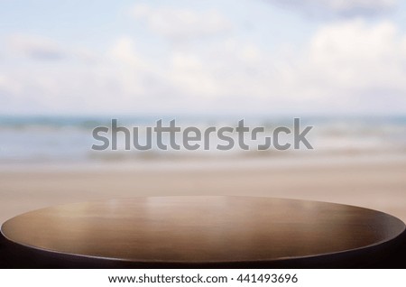 Selected focus empty brown wooden table on the tropical sea beach  and sunny day and space for product display montage