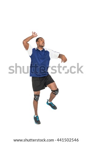 Sportsman posing while playing volleyball on white background