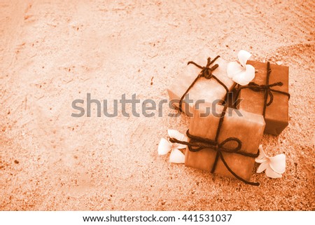 gift box from nature and flower on sand beach  background, vintage color tone. decoration for Christmas and Happy new year holiday.
