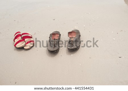 Two pairs of shoes left on the beach