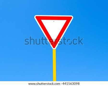 Blank give way sign on clear blue sky background (with clipping path)